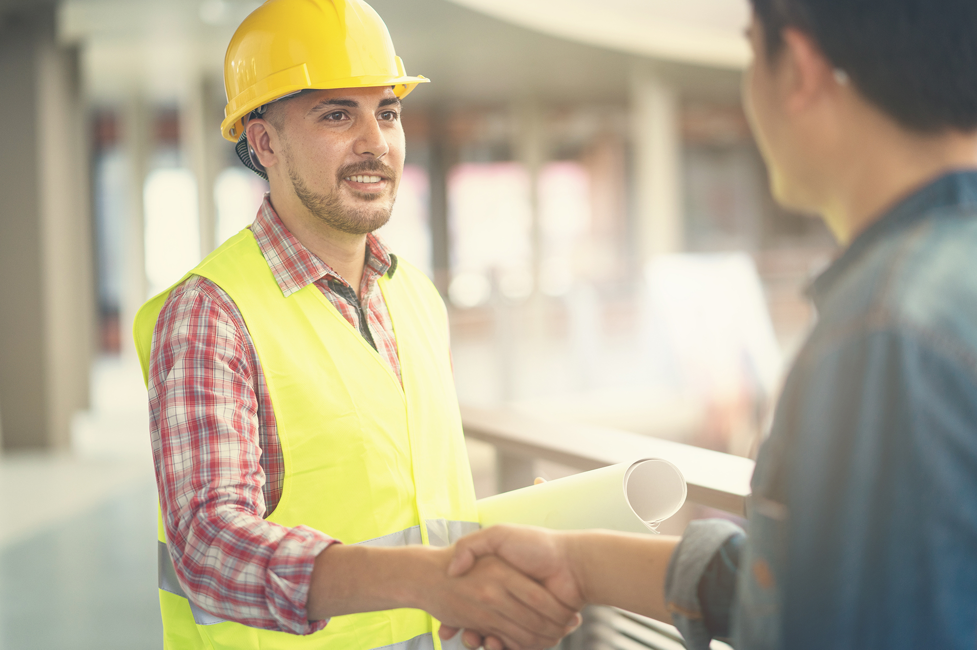 Sales construction worker shaking hands